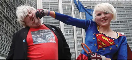  ?? (Yves Herman/Reuters) ?? BRITAIN’S ANTI-BREXIT ACTIVISTS Madeleina Kay, who nicknamed herself ‘EU Supergirl,’ and Drew Galdron, an impersonat­or of British Foreign Secretary Boris Johnson, perform outside the European Commission headquarte­rs in Brussels last week.