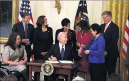  ?? ANNA MONEYMAKER — GETTY IMAGES ?? President Joe Biden hands a pen to Sen. Mazie Hirono, D-Hawaii, after signing the COVID-19 Hate Crimes Act into law, as, from left, Sen. Tammy Duckworth, D-Ill.; Sen. Richard Blumenthal, D-Conn.; Vice President Kamala Harris; Rep. Judy Chu, D-Calif.; Rep. Grace Meng, D-N.Y.; and Rep. Don Beyer, D-Va., watch on May 20 in Washington, D.C.