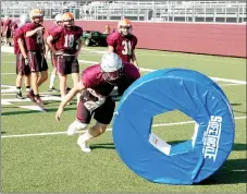  ?? Graham Thomas/Siloam Sunday ?? Siloam Springs senior Spenser Pippin launches into a tackling dummy during football practice on Thursday at Panther Stadium.