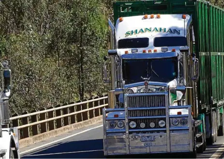  ?? PHOTO: BRUCE HONEYWILL ?? A schmick looking Kenworth of Shanahans crosses Dogwood Creek at Miles in Queensland.