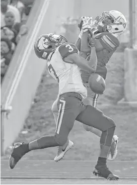  ?? Jerry Baker ?? Yates wide receiver Bernard Brown, right, battles Wheatley free safety Gervon Livingston during the second quarter Saturday night.