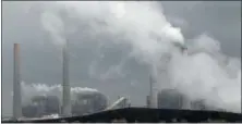  ?? FILE PHOTO ?? In this March 16, 2011, file photo, exhaust rises from smokestack­s in front of piles of coal at NRG Energy’s W.A. Parish Electric Generating Station in Thompsons, Texas.