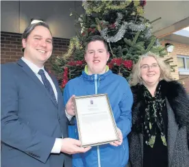  ??  ?? Festive feeling (From left) MSP Tom Arthur, pupil Lewis Nicholson and headteache­r Catherine Gilius