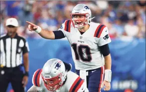  ?? Mike Stobe / Getty Images ?? The Patriots’ Mac Jones looks to pass the ball against against the Giants on Sunday at MetLife Stadium in East Rutherford, N.J.