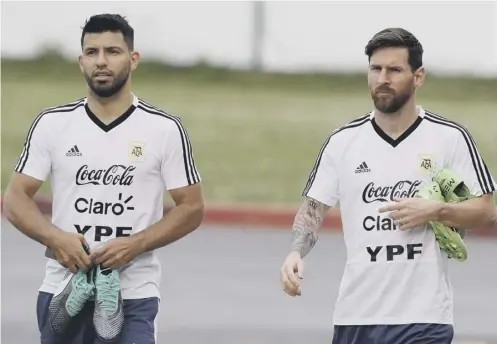  ??  ?? 0 Lionel Messi, right, turns up for training with Sergio Aguero. Aguero scored in the draw with Iceland but Messi missed a penalty.