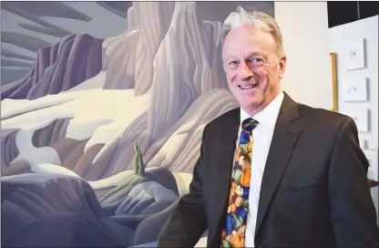  ?? STEVE MACNAULL/The Daily Courier ?? Stewart Turcotte, 69, the owner of Hambleton Galleries is the 33rd nominee for Kelowna Top Forty Over 40. He’s pictured here in front of the four-foot-by-four-foot painting Black Tusk by Peachland artist Kenneth T. Harrison.