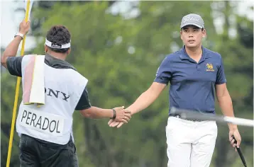  ??  ?? Peradol Panyathana­sedh with his caddie at Linkou lnternatio­nal Golf and Country Club.