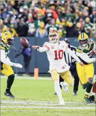  ?? Carlos Avila Gonzalez / The San Francisco Chronicle ?? San Francisco 49ers quarterbac­k Jimmy Garoppolo hands the ball off against the Green Bay Packers in the NFC divisional round playoff game on Jan. 22.