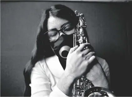  ?? AP PHOTO/GINNETTE RIQUELME ?? Maria Elena Ríos holds her saxophone at the end of a rehearsal at the National Autonomous University of Mexico music department, in Mexico City, on Feb. 14.