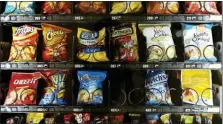  ?? PATRICK SISON - THE ASSOCIATED PRESS ?? This Saturday, Sept. 7 photo shows items in a vending machine in New York. Americans are addicted to snacks, and food experts are paying closer attention to what that might mean for health and obesity.