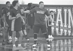  ??  ?? Shadow Mountain head coach Mike Bibby talks during a drill at Shadow Mountain High on Monday. PATRICK BREEN/THE REPUBLIC