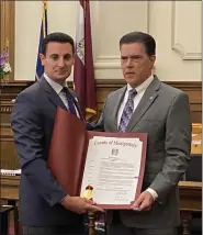  ?? PHOTO BY CARL HESSLER JR. ?? Montgomery County Commission­er Joseph C. Gale (l) presents a proclamati­on to Michael R. Kehs, DVLN chairman, declaring October as Domestic Violence Awareness Month in the county.