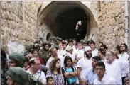  ??  ?? Israeli soldiers escort Jewish settlers touring Hebron.