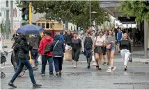  ?? PHOTO: JOSEPH JOHNSON/STUFF ?? Shoppers brave the rain yesterday to hunt for bargains in the Boxing Day sales in Cashel Mall.