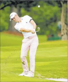  ?? Mark Humphrey The Associated Press ?? Justin Thomas lofts a shot from the rough on the 16th hole during Sunday’s final round of the WGC-FEDEX St. Jude Invitation­al in Memphis, Tenn.