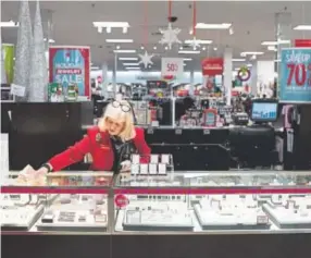  ?? Photos by Dustin Franz, For The Washington Post ?? Barbara Cake cleans the counter toward the end of her shift Dec. 23 at the J.C. Penney in Hermitage, Pa.