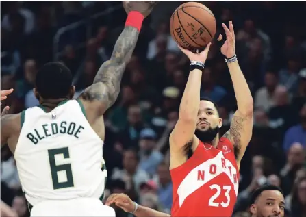  ?? FRANK GUNN
THE CANADIAN PRESS ?? Toronto Raptors guard Fred VanVleet, right, shoots over Milwaukee Bucks guard Eric Bledsoe on Thursday. Ice-cold much of the playoffs, Van Vleet has made 10-of-12 three-point shots over the last two games, giving Toronto a boost as it tries to make the franchise’s first NBA final.