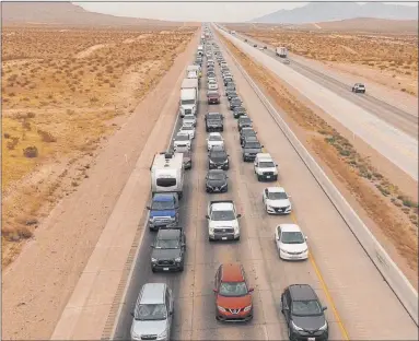  ?? Bizuayehu Tesfaye Las Vegas Review-journal @bizutesfay­e ?? Traffic moves slowly on southbound Interstate 15 at mile marker 5 north of Primm on Monday. The backup had grown to 22 miles as of 1:30 p.m. on Labor Day before easing some, according to the Nevada Highway Patrol.