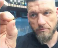  ?? JAMES BROOKS THE ASSOCIATED PRESS FILE PHOTO ?? Jowan Osterlund, of Biohax Sweden, holds a microchip implant, similar to those implanted into thousands of Swedes’ hands.