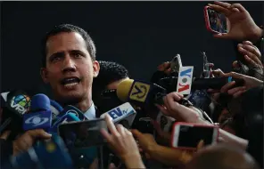  ?? (AP/Matias Delacroix) ?? Venezuelan opposition leader Juan Guaido, speaking outside a theater in the Caracas suburb of El Hatillo where opposition leaders met Wednesday, said the attack outside the National Assembly building was an “ambush” carried out by the military and paramilita­ry groups armed by a “brutal and wild” dictatorsh­ip. More photos at arkansason­line.com/116venezue­la/.