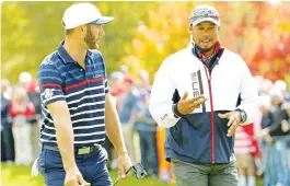  ?? (Reuters) ?? TEAM USA vicecaptai­n Tiger Woods (right) talks with Player of the Year Dustin Johnson of the United States during a practice round for the 41st Ryder Cup at Hazeltine National Golf Club last month.