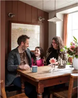  ??  ?? THIS PAGE, FROM TOP The small building had been used as a dwelling for 200 years; the kitchen units look as if they have always been there, painted in dark brown Chimney Brick by Little Greene; behind Alan, Isla
and Ana, a vintage map of the area helps visitors get their bearings OPPOSITE The kitchen was made from reclaimed timber, with a zinc worktop. Space-saving open shelving in elm displays Ana’s vintage crockery