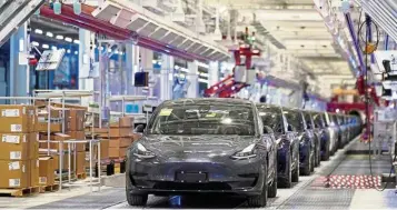  ?? — Reuters ?? New jobs: A file picture showing Tesla China-made Model 3 vehicles at a delivery event in Shanghai. Tesla plans to ship cars made at the Shanghai actory to other countries in Asia, including Singapore.