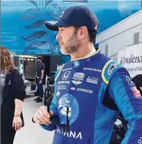  ?? Jenna Fryer / Associated Press ?? Jimmie Johnson prepares for practice at the Grand Prix of Long Beach on Saturday. Johnson fractured his hand in a crash on Friday and was fitted with a carbon fiber splint that he tested in Saturday practice.