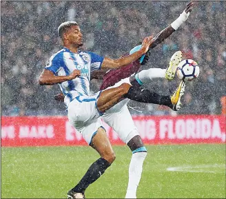  ??  ?? West Ham’s Michail Antonio (rear), and Huddersfie­ld’s Steve Mounie challenge during the English Premier League soccer match between West Ham United and Huddersfie­ld Town at London Stadium in London, on Sept 11.(AP)