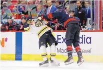  ?? KARL B. DEBLAKER/ASSOCIATED PRESS ?? Carolina’s Brett Pesce (22, right) collides with Boston’s Brad Marchand during the first period of Game 2 on Wednesday night.