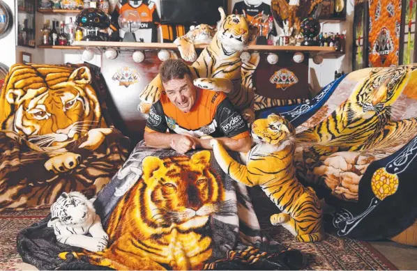  ??  ?? BALMAIN BOY: Cairns’ biggest Tigers fan Ken Olson has more than 50 pieces of memorabili­a and supporter merchandis­e on display in his ‘Tigers' den’. Picture: ANNA ROGERS