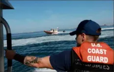  ?? Joe Raedle/Getty Images ?? United States Coast Guard Petty Officer 3rd Class Boatswain’s Mate Sam Flannery stands aboard a 33-foot response boat June 9 as it navigates through Biscayne Bay during a media event in Miami Beach, Fla.