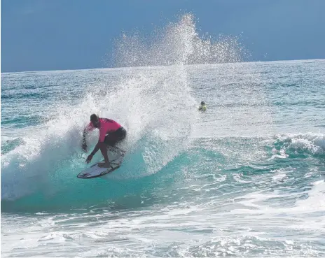  ??  ?? Former world champion Mick Fanning sends some spray to the sky with a backside turn at Duranbah. Pictures: Supplied.