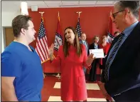  ?? (Arkansas Democrat-Gazette/Thomas Metthe) ?? Gov. Sarah Huckabee Sanders (center) talks with John Brown University nursing graduate Tanner Meyer (left) and Jim Krall (right), vice president of advancemen­t at John Brown, after the Arkansas Department of Commerce gave away grant money to the state’s nursing schools on Monday in Little Rock.