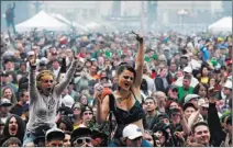  ?? BRENNAN LINSLEY/ THE ASSOCIATED PRESS ?? Members of a crowd numbering in the tens of thousands smoked marijuana and listened to live music this past April at the Denver 420 pro-marijuana rally at Civic Center Park.