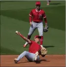 ?? ABBIE PARR – THE ASSOCIATED PRESS ?? Angels third baseman Gio Urshela can’t make the throw in time to get the Rangers’ Mitch Garver, who reached base on an infield single.