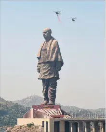  ?? SAM PANTHAKY AFP/GETTY IMAGES ?? Helicopter­s shower rose petals on the “Statue Of Unity,” dedicated to Sardar Vallabhbha­i Patel, near Vadodara in India’s Gujarat state.