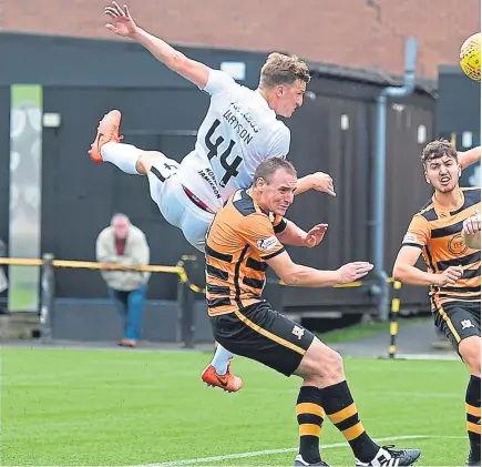  ?? Pictures: SNS Group. ?? Above: Paul Watson climbs highest to head in a Fraser Aird cross for United’s goal; below: Aird is denied by Wasps keeper Neil Parry as he tries to slide the ball into the home net.