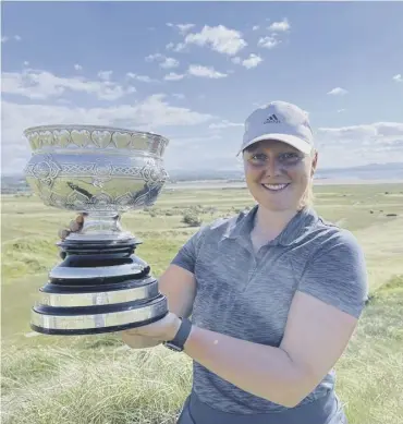  ??  ?? 0 Chloe Goadby shows off the Scottish Women’s Championsh­ip trophy after her win at Gullane