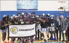  ?? Albertus Magnus Athletics ?? Members of the Albertus Magnus men’s basketball team hold up the championsh­ip banner after beating St. Joseph to win the GNAC championsh­ip Saturday.