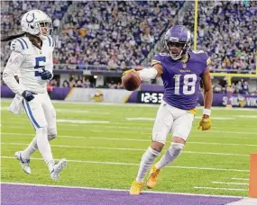  ?? Andy Clayton-King/Associated Press ?? Minnesota Vikings wide receiver Justin Jefferson (18) scores on an 8-yard touchdown reception next to Indianapol­is Colts cornerback Stephon Gilmore (5) on Dec. 17 in Minneapoli­s.