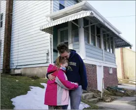  ?? MATT SLOCUM - THE ASSOCIATED PRESS ?? Melissa Weirich, right, hugs her daughter, Kacie Thompson, 9, outside the former home of her friend, Ava Lerario, Thursday, March 11, 2021, in Lansford, Pa. On May 26, 2020, Ava; her mother, Ashley Belson, and Ava’s father, Marc Lerario, were found fatally shot inside the home.