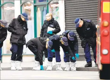  ?? Facundo Arrizabala­ga EPA/Shuttersto­ck ?? POLICE work at the spot where a man was killed by officers after he stabbed two people in London on Sunday. The man had been freed from prison days earlier after serving time for Islamist-related terrorism offenses.