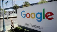  ?? AP JEFF CHIU ?? In this May 1, 2019, file photo a man walks past a Google sign outside with a span of the Bay Bridge at rear in San Francisco. A group of states are expected to announce an investigat­ion into Google on Monday, Sept. 9, to investigat­e whether the tech company has become too big.