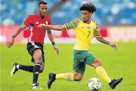  ?? Picture: ANESH DEBIKY/AFP ?? MY BALL: Bafana midfielder Keagan Dolly, right, beats Libya forward Hamdou Elhouni to the ball during the 2019 Africa Cup of Nations qualifier at the weekend. Dolly has voiced his support for under-pressure Mamelodi Sundowns coach Pitso Mosimane