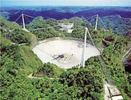  ?? [PHOTO COURTESY OF NATIONAL SCIENCE FOUNDATION] ?? Arecibo Observator­y radio telescope that detected the Ross 128’s strange emissions.