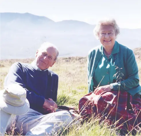  ?? PHOTO BY THE COUNTESS OF WESSEX VIA GETTY IMAGES ?? This photo released by Buckingham Palace on Friday shows Queen Elizabeth II and Prince Philip, Duke of Edinburgh, posing in a personal photograph at the top of the Coyles of Muick, taken by The Countess of Wessex in 2003.