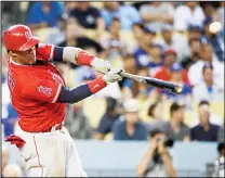  ??  ?? Los Angeles Angels’ Yunel Escobar hits a two-run single during the third inning of a baseball game against the Los Angeles Dodgers on June 26,
in Los Angeles.