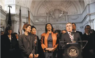  ?? Lea Suzuki / The Chronicle ?? San Francisco City Attorney Dennis Herrera speaks during a news conference as he stands with acting Mayor London Breed (center) at City Hall after the death of Mayor Ed Lee on Tuesday morning.