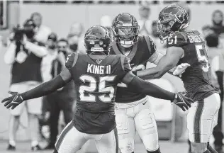  ?? Brett Coomer / Staff photograph­er ?? Texans safety Eric Murray celebrates with cornerback Desmond King II (25) and linebacker Kamu Grugier-Hill (51) after intercepti­ng a pass by Dolphins quarterbac­k Jacoby Brissett.